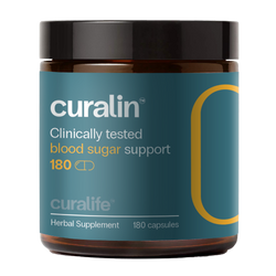 A bottle of CurLife Blood Sugar Support capsules next to a variety of natural ingredients.