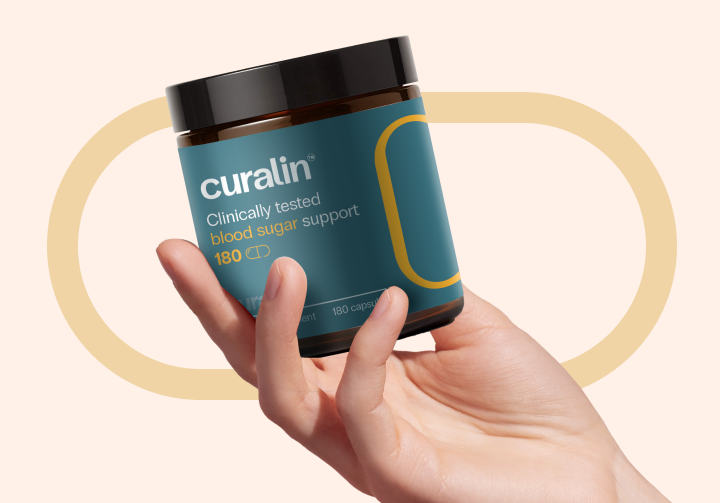 A hand holding a bottle of Curcumin, a clinically tested blood sugar support supplement.